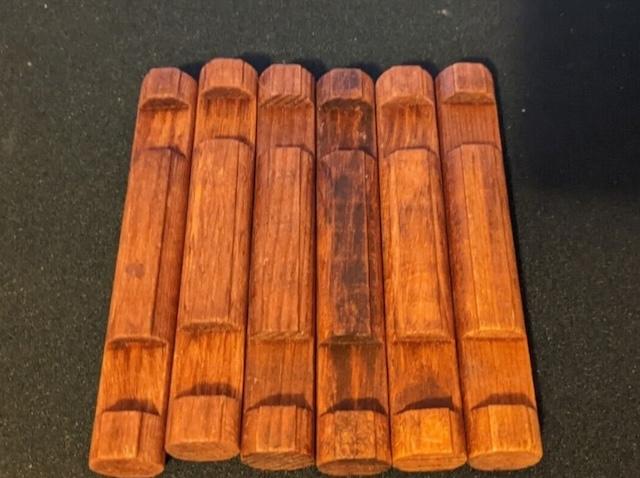 A set of classic Lincoln Logs wooden pieces, a nostalgic toy that allows children to build their own miniature log cabins.